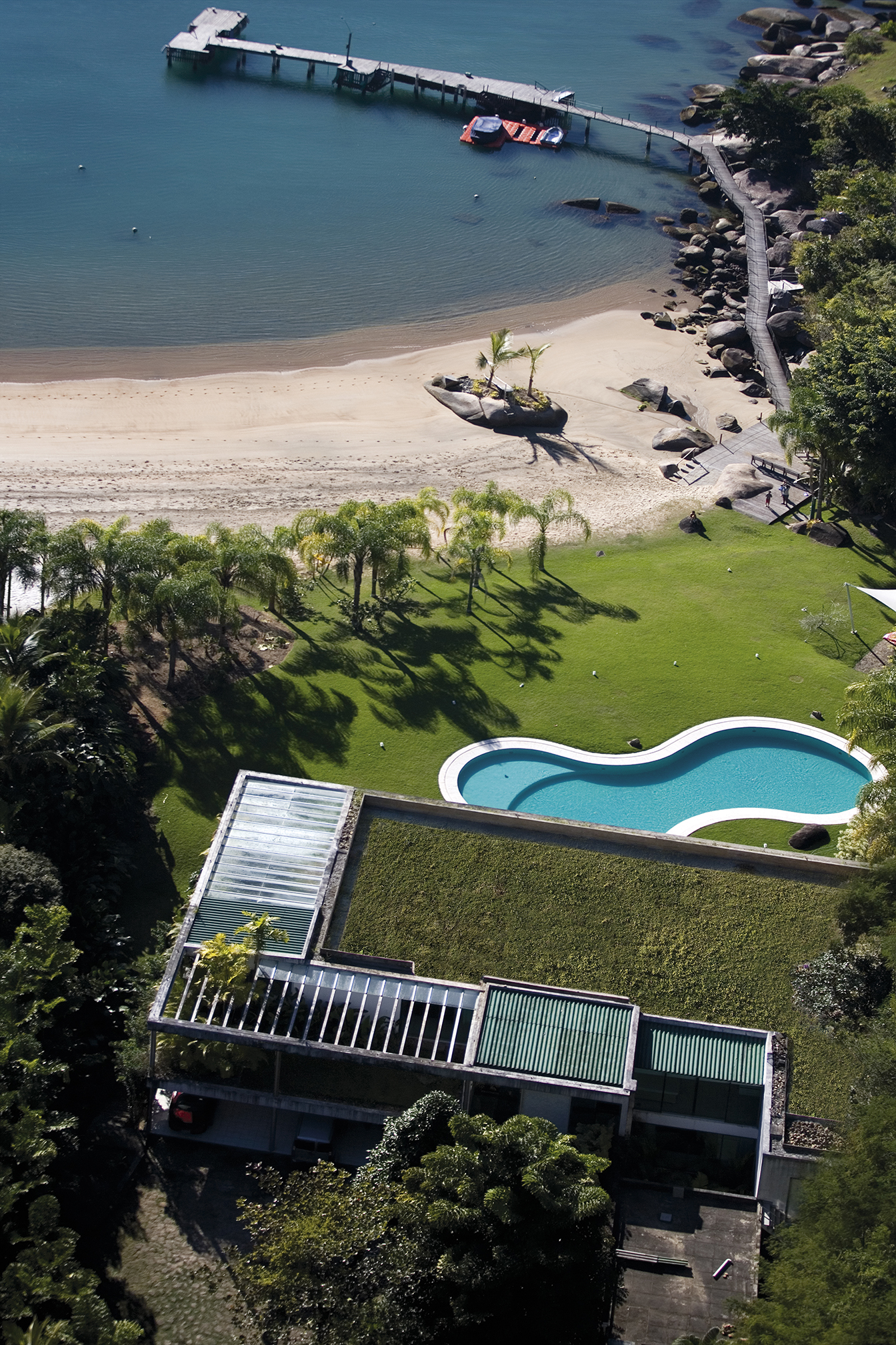 House in the foreground and beach and pier in the background